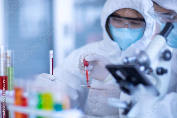 Obraz The Scientists are experimenting with chemicals in the laboratory. Concept, The scientists wear white protective clothing is experimenting with drug anti- Coronavirus, Covid2019