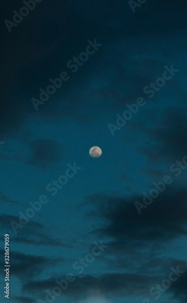 Fototapeta Moon unsigned on a cloudy sky