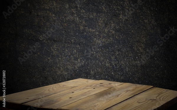 Fototapeta Wood table and black concrete wall background. can be used to install the product..