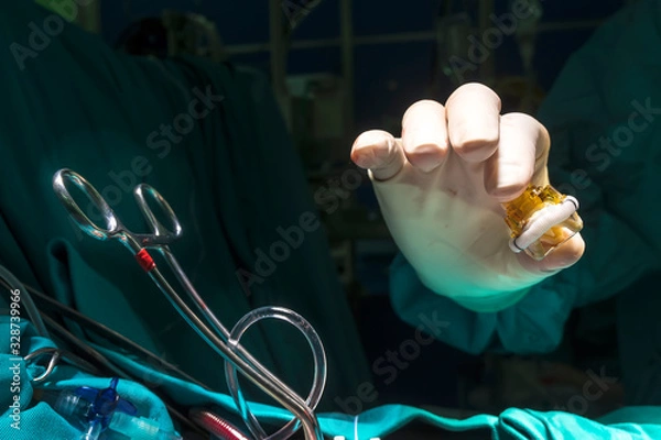 Obraz Close up image of aortic valve implant in surgeon hand during open heart surgery.