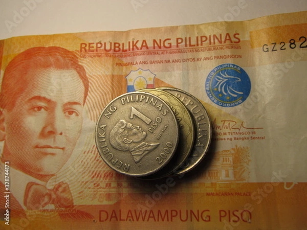 Obraz Different Philippines coins on banknote background.