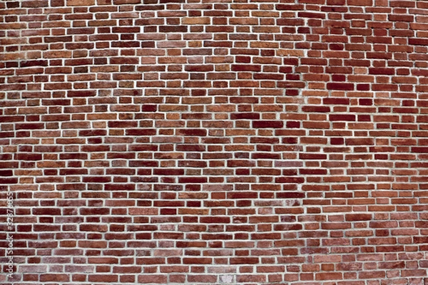 Fototapeta background of convex dark red brick wall