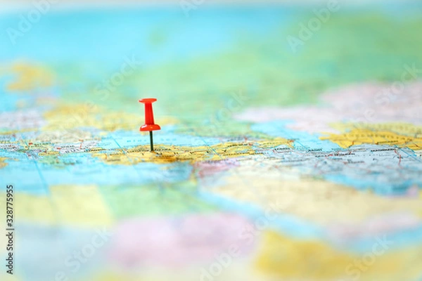 Fototapeta pushpin on world map with blurry background
