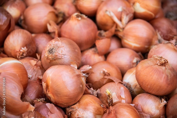 Fototapeta Freshly collected onions from agriculture for kitchen use in a street market for sale to the consumer public that comes to purchase