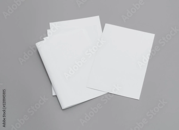 Fototapeta Blank portrait A4. Mock-ups white paper isolated on gray background. can use banners magazine products business texture newspaper.