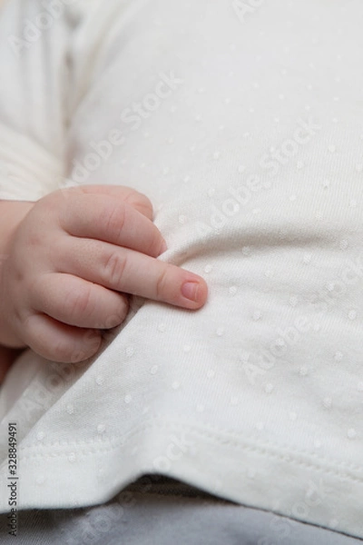 Fototapeta Middle finger, an offensive gesture from a newborn baby
