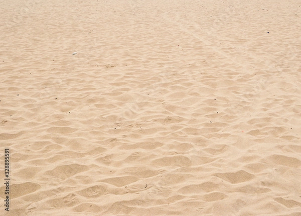 Fototapeta Clean sandy beach surface with subtle ripples and no visible litter, showcasing a natural and undisturbed shoreline.