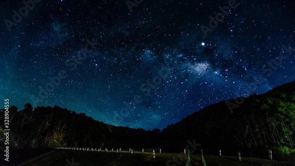 Fototapeta Milky way galaxy with stars and space in the universe background at thailand