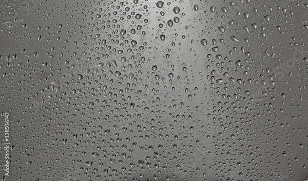 Fototapeta Drops of water on the glass, cloudy wether outside the window