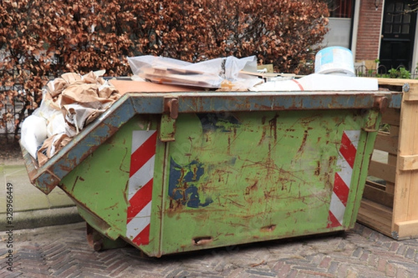 Fototapeta Loaded garbage dumpster
