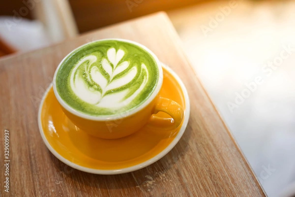 Fototapeta Cup of Matcha green tea latte in cafe