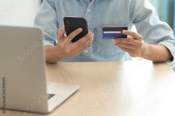 Fototapeta using smartphone and credit card online shopping