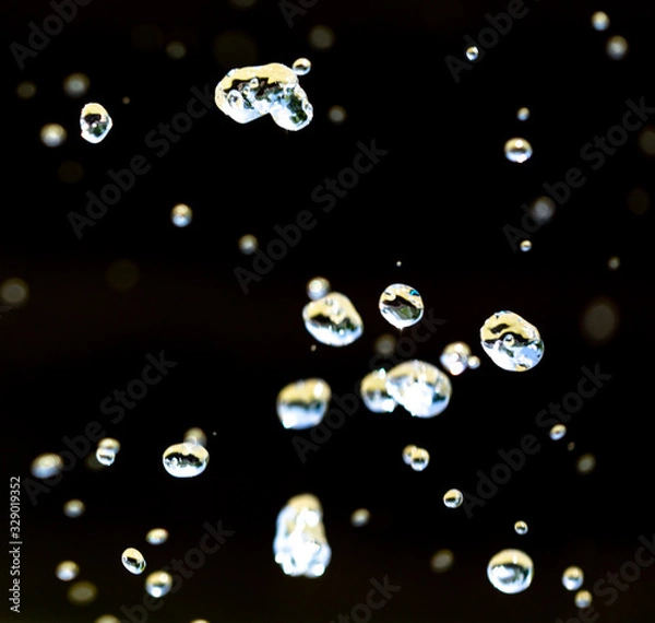 Fototapeta Water splashing from a fountain on summer nature