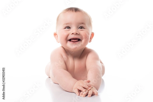 Fototapeta Studio shot of happy 7 months old baby lying on belly, lifting head up. Cut out on white image