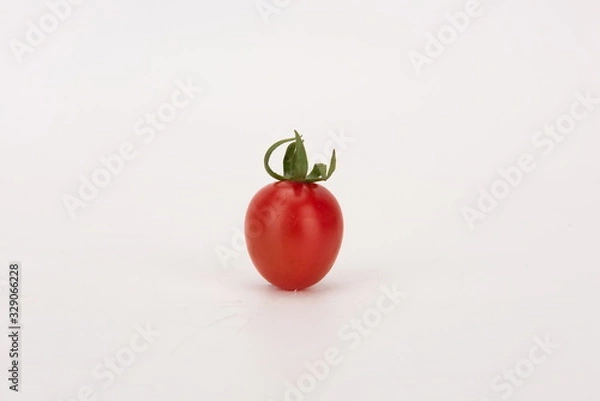 Fototapeta The cherry tomato is a type of small round tomato believed to be an intermediate genetic admixture between wild currant-type tomatoes and domesticated garden tomatoes. with white background.