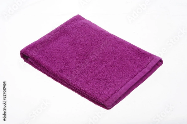 Fototapeta purple towel lies on a white background of isolate