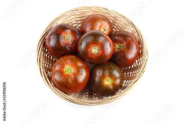 Obraz Dark tomatoes on wicker plate
