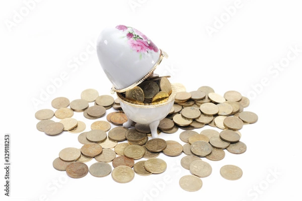 Obraz Coins on the ceramic egg