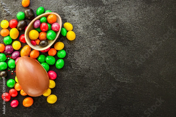 Fototapeta chocolate egg and candy Happy  easter decor. menu concept background. top view. copy space