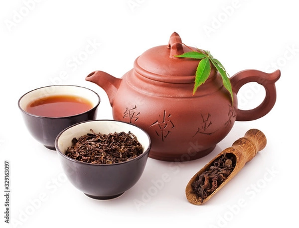 Fototapeta Chinese tea ceremony. Clay teapot with bowls and scoop of puer tea isolated on a white background.
