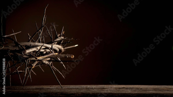 Fototapeta Dramatic image of crown of thorns against dark red background as symbol of death and resurrection of Jesus Christ
