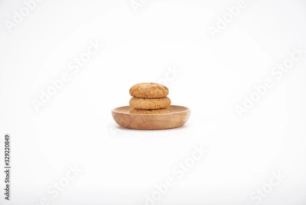 Fototapeta Cookies on a white ceramic plate on the gray kitchen table. Top view with copy space.Chocolate chip cookies isolated on a white background. Cookies homemade cakes.