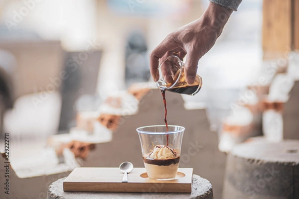 Fototapeta Affogato coffee: One shot hot espresso Topped on vanilla ice cream decorated with whipped cream and caramel