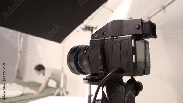 Fototapeta Studio medium format digital camera setup on tripod and professional equipment in studio with black and white color softbox and lighting set for still photo shooting or high resolution video or movie 