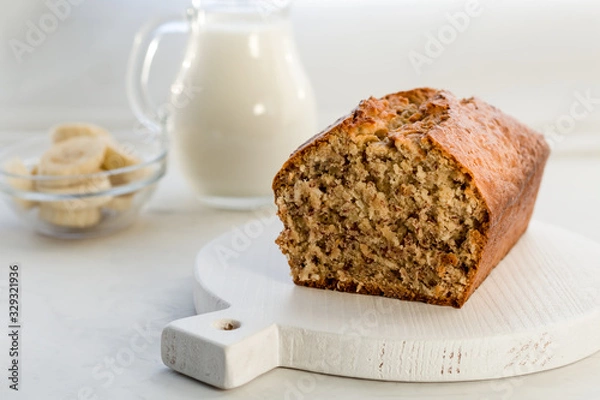 Fototapeta Nar bread with coconut and milk on a light gray background. Homemade delicious pastries. Side view, close- up, copy space.