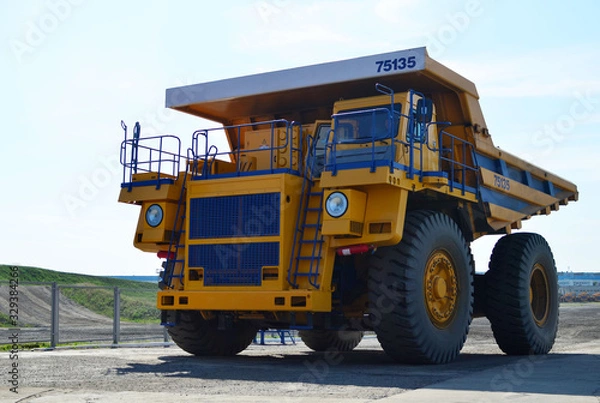 Fototapeta Giant mining dump truck, after being discharged from the conveyor, is tested at the factory test site. Heavy-duty truck manufacture by the heavy vehicle plant.