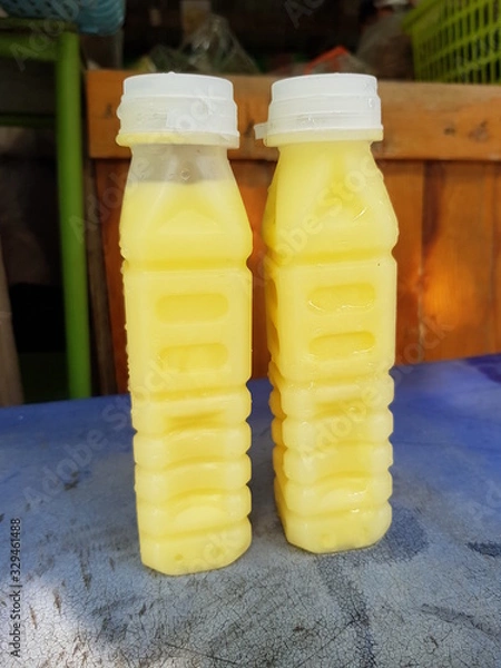 Obraz Closeup of fresh corn milk for sale in the park.  Nutritious drink concept.