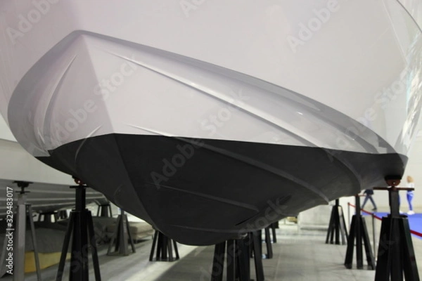 Fototapeta Antifouling protective coating on the bottom waterline of the motor boat on the slipway, ship maintenance service
