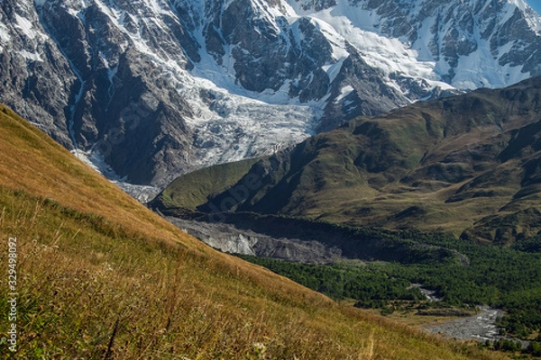 Fototapeta Mountain walls with glacier and its tongue Svaneti Georgia