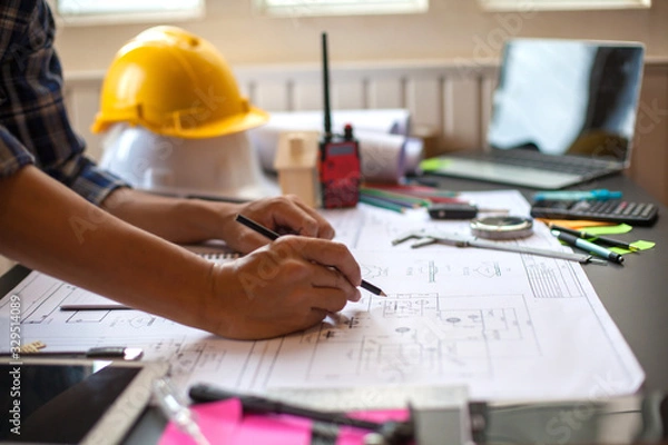Fototapeta Concept Architect and desk of Architectural project in construction site or office building with mining light