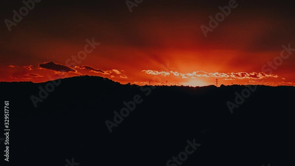 Obraz magical sunset on top of a hill in the middle of the natural and city