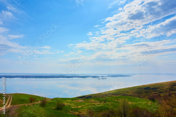 Fototapeta Mountain sea shore in the fall against the blue sky with clouds.