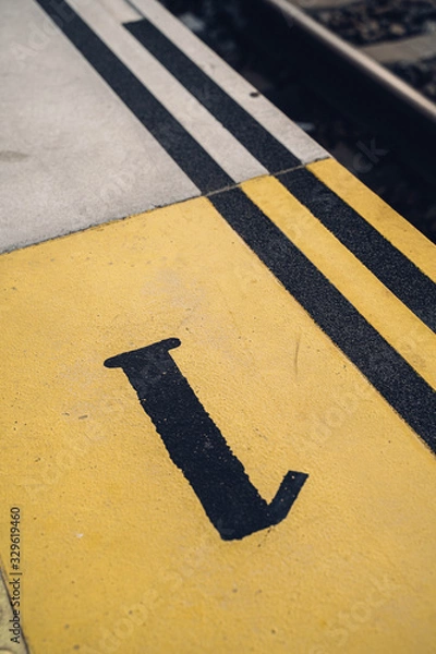 Obraz platform 1 marked on the floor of a speed bump at the train station