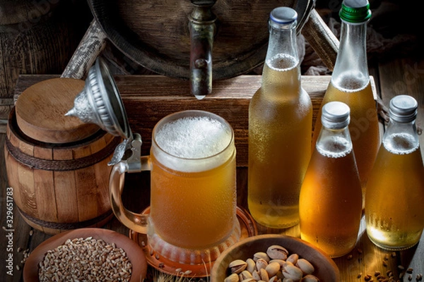 Fototapeta Light beer in a glass on a table in composition with accessories on an old background