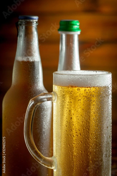 Fototapeta Light beer in a glass on a table in composition with accessories on an old background
