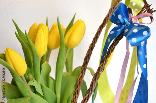 Fototapeta Spring composition: two easter whips with bunch of yellow tulips