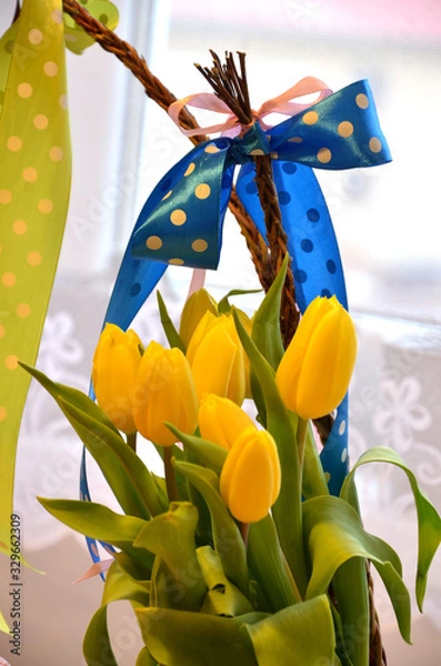 Fototapeta Spring composition: two easter whips with bunch of yellow tulips