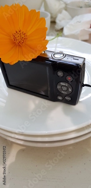 Obraz Closeup of compact camera on white plate blurred background.  Technology equipment concept.
