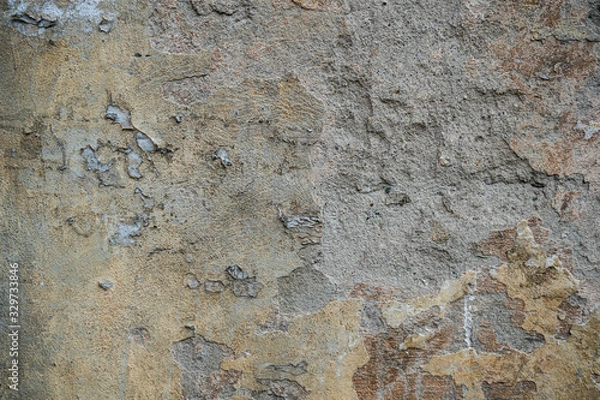 Fototapeta Texture of an old wall covered with paint. Background image of a worn paint coated surface