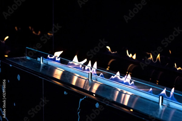 Obraz fire in a biofireplace.  Modern bio fireplot fireplace on ethanol gas.