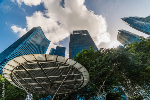Fototapeta Looking up in Singapore at tall buildings, one of the most developed parts of Asia