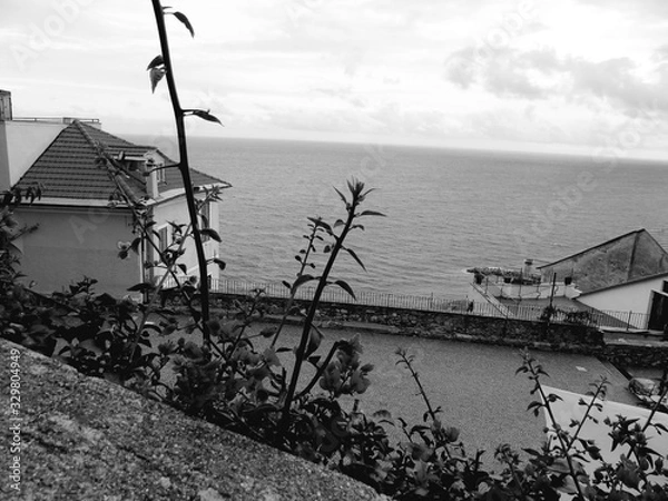 Fototapeta Cervo Ligure, Italy - 02/15/2020: Travelling around the Riviera Ligure in winter days. Beautiful photography of the small vilagges near the sea with typical old buildings.
