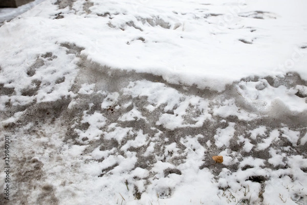 Fototapeta Dirty snow spring background. Old and dirty snow texture. Natural background. Snow mixed with coal soot, poor ecology. Environmental pollution.
