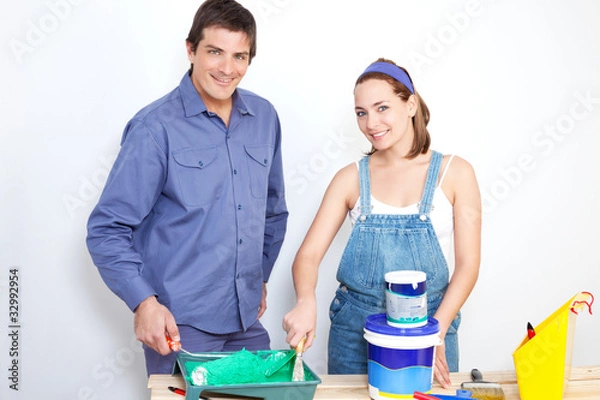 Fototapeta Portrait of happy couple with paint tools