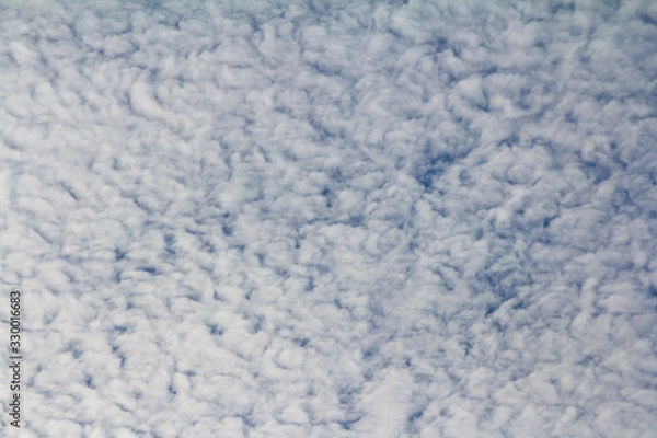 Obraz Backdrop from ragged clouds on a blue sky