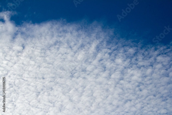 Obraz Backdrop from ragged clouds on a blue sky